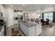 Open kitchen with center island, stainless steel appliances and view into dining area at 8230 S White Crow St, Aurora, CO 80016