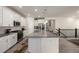 Kitchen with large island, stainless steel appliances, and sleek white cabinetry at 8230 S White Crow St, Aurora, CO 80016