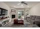Cozy living room features fireplace, ceiling fan and view to patio and outdoor space at 8230 S White Crow St, Aurora, CO 80016