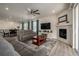 Open concept living space features fireplace, ceiling fan and view to open dining area at 8230 S White Crow St, Aurora, CO 80016