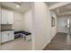 Mudroom area with tile flooring, storage cabinets, bench seating, and access to the front door at 8230 S White Crow St, Aurora, CO 80016