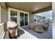 Covered patio with furniture and sliding door access at 8230 S White Crow St, Aurora, CO 80016