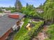 Well-maintained backyard with lush lawn, play set, trampoline, mature trees, and a charming garden at 5200 W Rowland Ave, Littleton, CO 80128