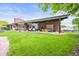 Expansive backyard featuring lush greenery, outdoor furniture, hammocks, and mature trees at 5200 W Rowland Ave, Littleton, CO 80128