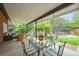 Backyard patio featuring a glass table, outdoor seating, a trampoline and a charming hammock for relaxation at 5200 W Rowland Ave, Littleton, CO 80128