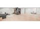 Open basement with a fireplace, wood floors, and a cozy seating area at 5200 W Rowland Ave, Littleton, CO 80128