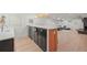 Basement bar area featuring a white countertop, dark cabinets, and pendant lighting at 5200 W Rowland Ave, Littleton, CO 80128