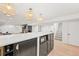 Open basement featuring a bar area, fireplace, hardwood floors, and ample lighting at 5200 W Rowland Ave, Littleton, CO 80128