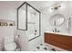 Modern bathroom featuring white subway tiles, a glass-enclosed shower-tub, and a custom vanity at 5200 W Rowland Ave, Littleton, CO 80128