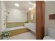 Modern bathroom features double sinks, a soaking tub, and stylish gold fixtures at 5200 W Rowland Ave, Littleton, CO 80128