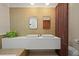 Sleek bathroom with floating double vanity, stylish mirrors, and modern gold fixtures at 5200 W Rowland Ave, Littleton, CO 80128