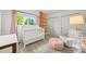 Bright bedroom with a large window, closet space, and cozy decor elements at 5200 W Rowland Ave, Littleton, CO 80128