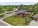 Charming single-Gathering home with a well-manicured lawn, mature trees, and a classic brick facade at 5200 W Rowland Ave, Littleton, CO 80128