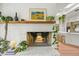 Close up of the living room fireplace with a wooden mantel and stylish decor at 5200 W Rowland Ave, Littleton, CO 80128