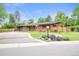 Charming red brick home with landscaped yard, bright orange door and attached garage at 5200 W Rowland Ave, Littleton, CO 80128