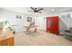 This bright office is carpeted and features a ceiling fan, modern desk and a vibrant red cabinet at 5200 W Rowland Ave, Littleton, CO 80128