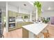 Bright kitchen featuring a large island with white countertops and green cabinets at 5200 W Rowland Ave, Littleton, CO 80128