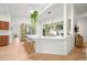 Modern kitchen featuring a large center island with white countertops and green cabinetry at 5200 W Rowland Ave, Littleton, CO 80128