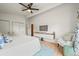 Cozy main bedroom with hardwood floors, closet space, and a sitting area with natural light at 5200 W Rowland Ave, Littleton, CO 80128