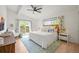 Light-filled main bedroom features a ceiling fan, hardwood floors, and private patio entrance at 5200 W Rowland Ave, Littleton, CO 80128