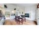 Bright dining room featuring hardwood floors, fireplace, and modern kitchen in an open-concept design at 592 Portside Ct, Lafayette, CO 80026