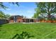 Expansive backyard featuring a well-maintained lawn and mature trees at 6040 Taft Ct, Arvada, CO 80004