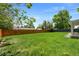 Spacious backyard featuring a lush lawn, mature trees, and privacy fencing at 6040 Taft Ct, Arvada, CO 80004