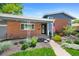 Charming single-story brick home with a cozy porch and beautifully landscaped front yard at 6040 Taft Ct, Arvada, CO 80004