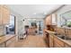 Bright kitchen with tile flooring, light wood cabinets, and a seamless flow to other rooms at 6040 Taft Ct, Arvada, CO 80004