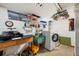 Basement laundry room features newer washer and dryer, utility sink, and shelving at 6040 Taft Ct, Arvada, CO 80004