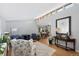 Open living space with vaulted ceilings, clerestory windows, and hardwood floors leading to dining area at 6040 Taft Ct, Arvada, CO 80004