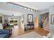 Bright and open living area with stairs leading to a bright dining room, creating seamless flow at 6040 Taft Ct, Arvada, CO 80004