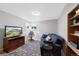 Relaxing living room features a blue sofa, TV, area rug, and built-in bookcase at 6040 Taft Ct, Arvada, CO 80004
