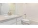 Bright, clean bathroom featuring a white vanity with a modern faucet and a bathtub with tile surround at 14065 Harrison St, Thornton, CO 80602