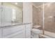 Modern bathroom featuring a glass-enclosed shower with a built-in seat and a vanity with a granite countertop at 14065 Harrison St, Thornton, CO 80602