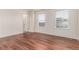Bedroom features wood floors, natural light and two large windows at 14065 Harrison St, Thornton, CO 80602