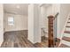 Bright entryway featuring wood floors, a staircase, and a convenient half-bathroom at 14065 Harrison St, Thornton, CO 80602