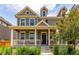 Two-story home with a covered porch, beautiful landscaping, and inviting curb appeal at 14065 Harrison St, Thornton, CO 80602