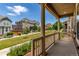 View from the porch of a home showcasing the well-manicured lawn, sidewalk, and neighborhood charm at 14065 Harrison St, Thornton, CO 80602