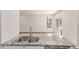 Open kitchen with granite counters looks into living area with lots of natural light at 14065 Harrison St, Thornton, CO 80602