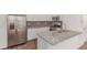 Modern kitchen boasts stainless steel appliances, granite counters, and wood floors at 14065 Harrison St, Thornton, CO 80602