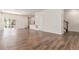 Open-concept living area with wood floors, providing versatile space for various layouts at 14065 Harrison St, Thornton, CO 80602