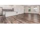 Spacious living area with wood floors, connected to the kitchen, ideal for entertaining and gatherings at 14065 Harrison St, Thornton, CO 80602