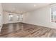 Bright living room with wood floors, neutral walls, and multiple windows offering plenty of natural light at 14065 Harrison St, Thornton, CO 80602