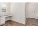 Bright room with stylish wood flooring, built-in desk and storage, and natural light from window at 14065 Harrison St, Thornton, CO 80602