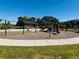 Community playground includes multiple play structures, swings, seating and surrounding green space at 14065 Harrison St, Thornton, CO 80602