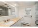 Bathroom with marble countertop, tiled backsplash, stylish fixtures, and window at 5000 S Chester St, Greenwood Village, CO 80111