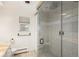 Bathroom featuring a tiled shower with glass door, marble countertop, window, and built-in storage at 5000 S Chester St, Greenwood Village, CO 80111