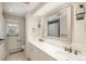 Bright bathroom featuring dual sinks, a large mirror, updated fixtures, and natural light at 5000 S Chester St, Greenwood Village, CO 80111