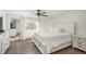 Bright bedroom with hardwood floors, a ceiling fan, and white trim throughout at 5000 S Chester St, Greenwood Village, CO 80111